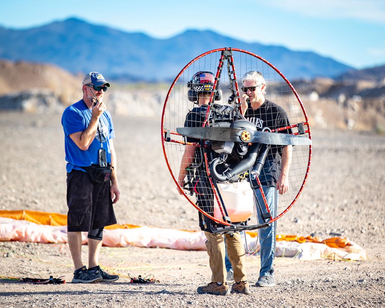 Paramotor instructor helping student